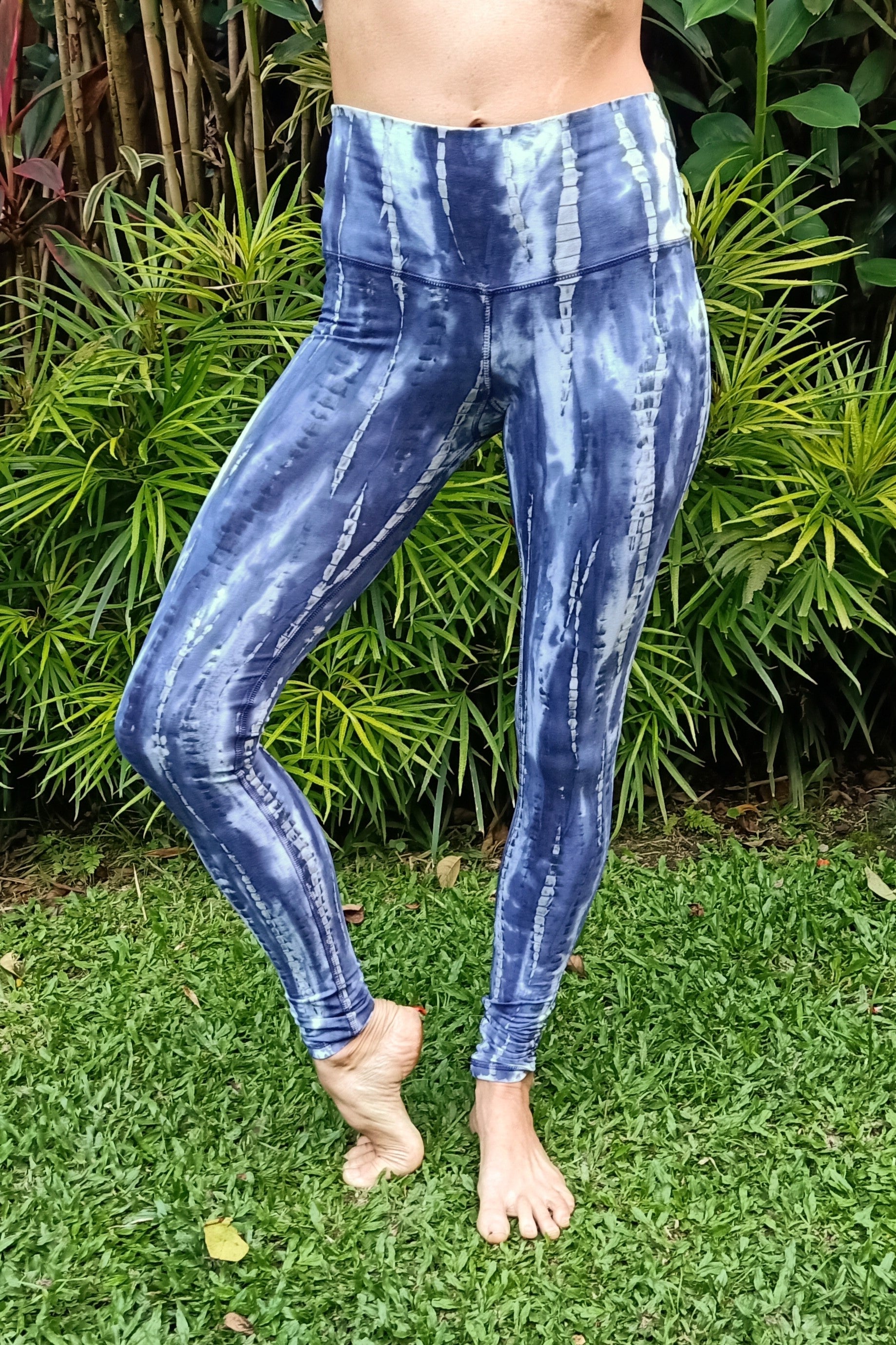 Front view of Wildflower tie dye Yoga Pants by Lotus Tribe. High waist and tight ankle worn by woman. Made of stretchy 90% cotton with 10% spandex fabric.