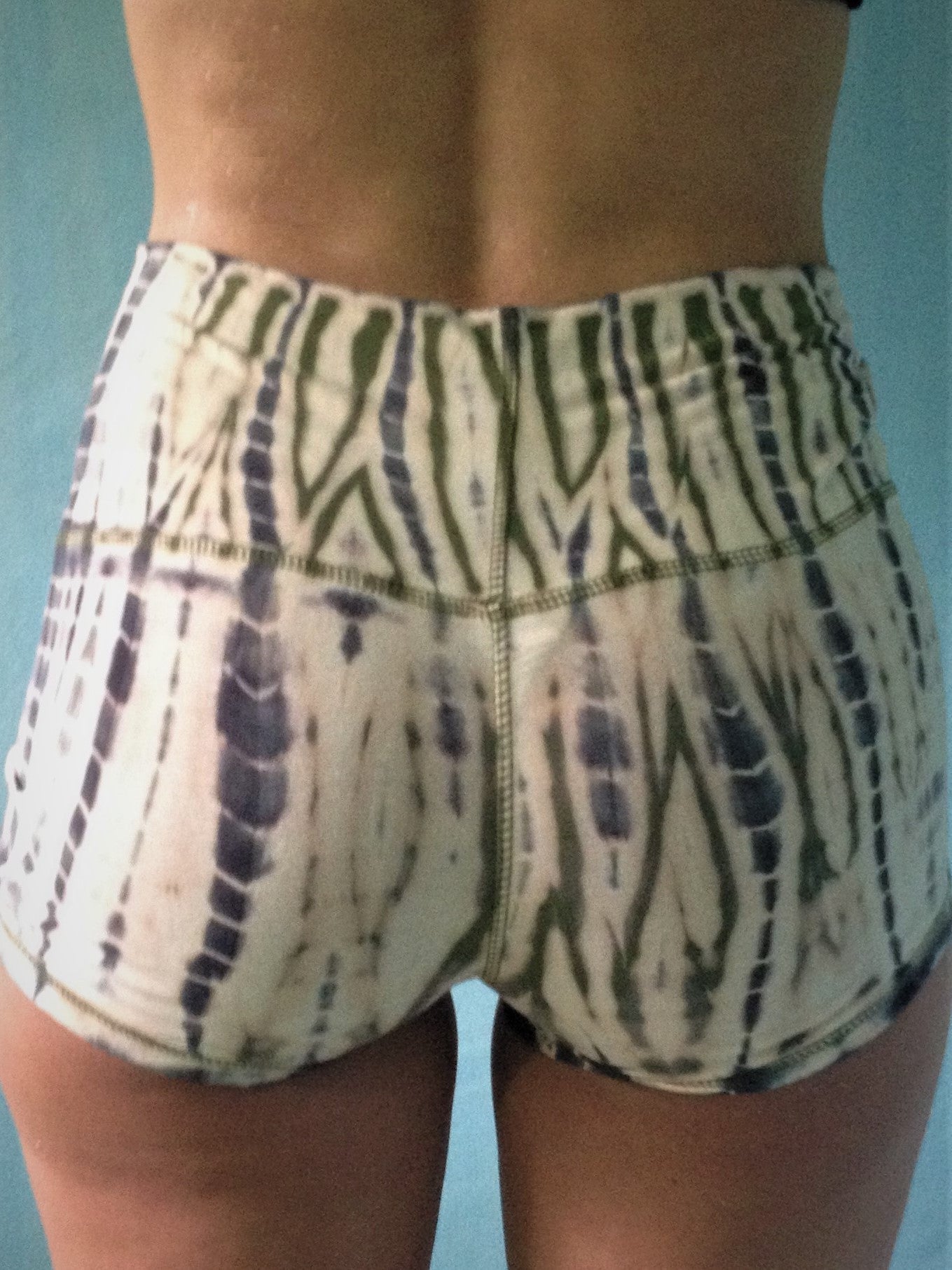 Soft and comfortable peach with green and grey tie dyed shorts with fold over waist for adjustable custom fit, can be worn higher waisted, or low on the hips.