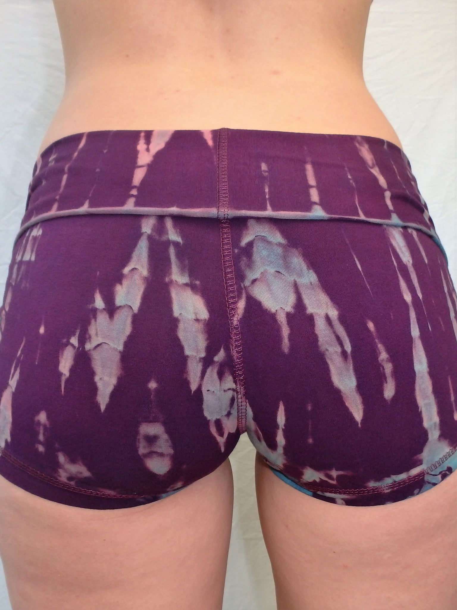 Lotus Tribe Clothing's curve hugging purple with lavender highlights tie dyed short shorts with fold over waist are soft and comfortable. Made in Bali of 90% cotton 10% spandex.