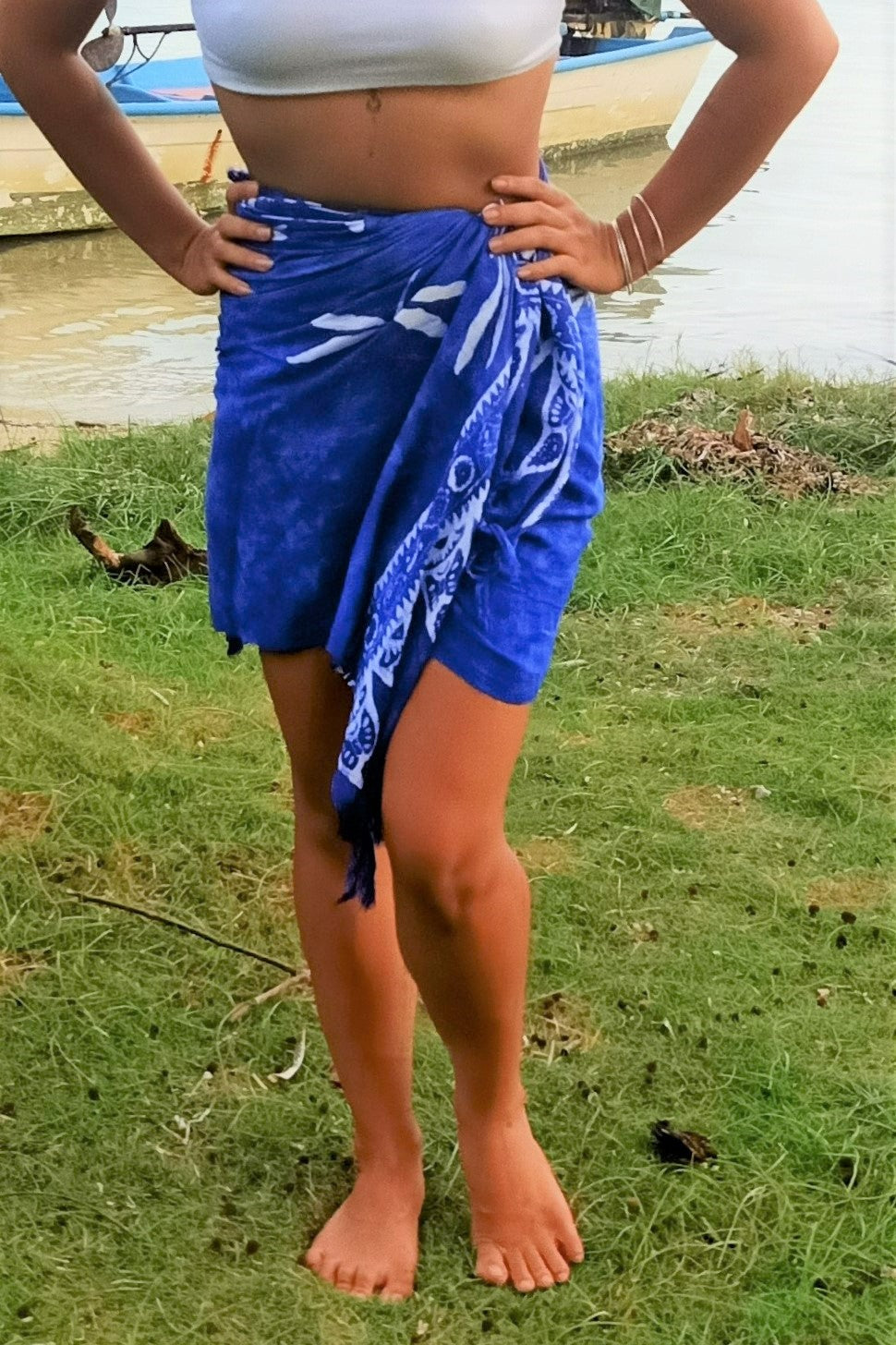 Sarong worn as wrap around mini skirt on woman. Blue with dragonfly pattern.