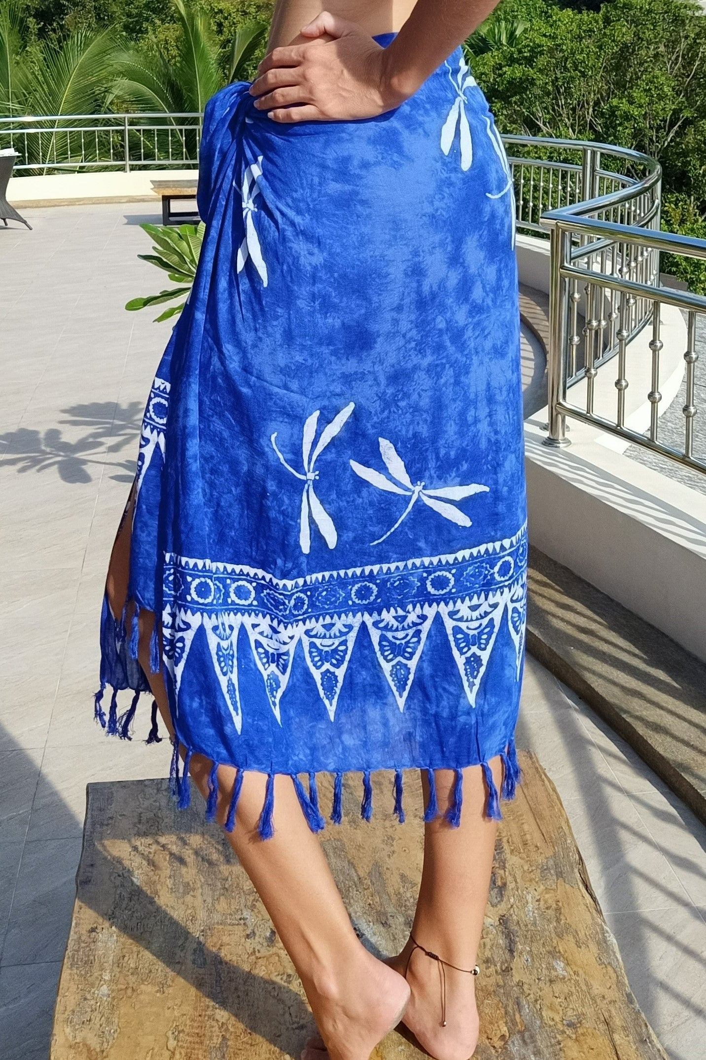 Blue sarong with white dragonflies batik worn as wrap around skirt. Makes great beach cover up.