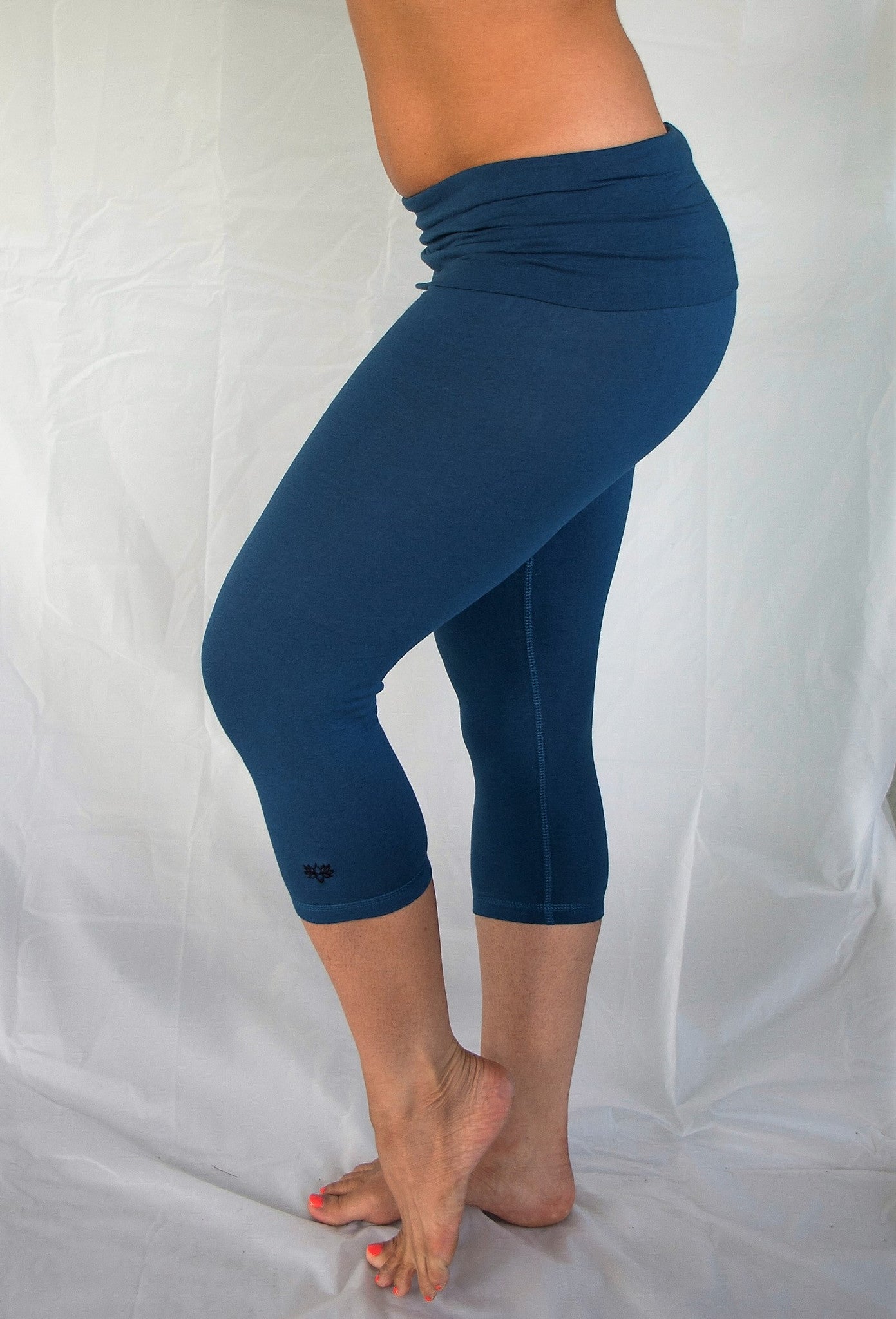 Solid colored cobalt blue 3/4 length Yoga Pants have a fold over waist that is adjustable to fit a longer torso or be worn lower on the hips. Soft 90% cotton and 10% spandex.