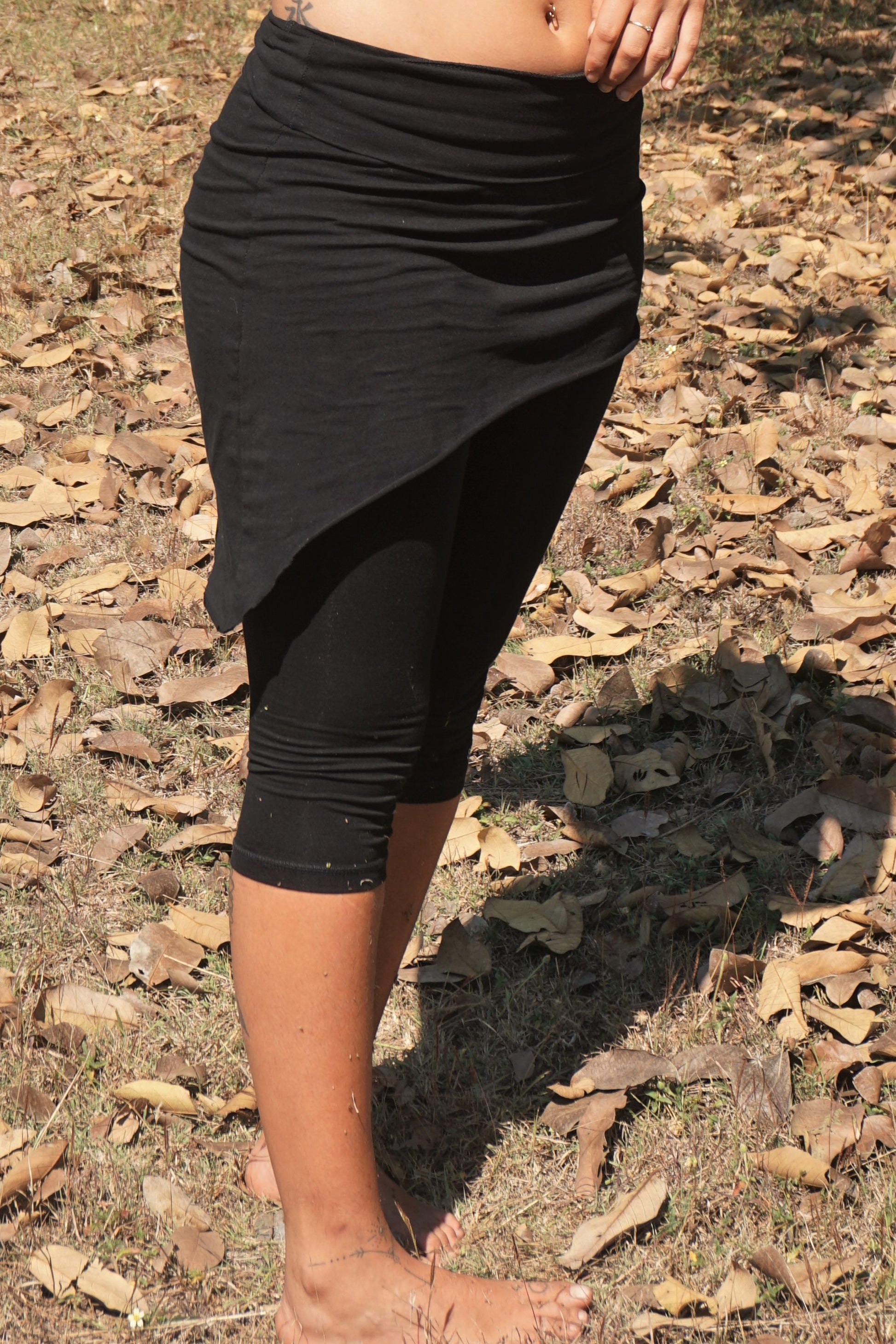 Assymetrical hem line skirt with fold top worn over 3/4 lenfth yoga pants both in Onyx. Great way to layer for fall fashion.