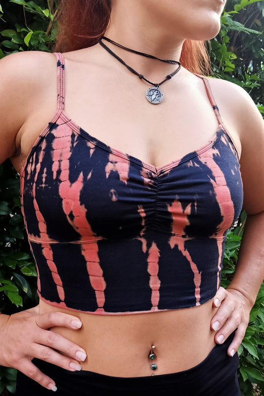 Fire tie dye Blissed Out Crop has adjustable spaghetti straps and puckering between breasts. Mid torso length 90% cotton with 10% spandeex. Black with burnt orange streaks.