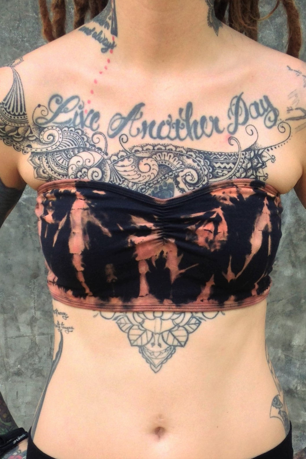 Cute little strapless Bandeau with puckering in the middle. Super stretchy, one size fits most. Black with burnt orange tie dye.
