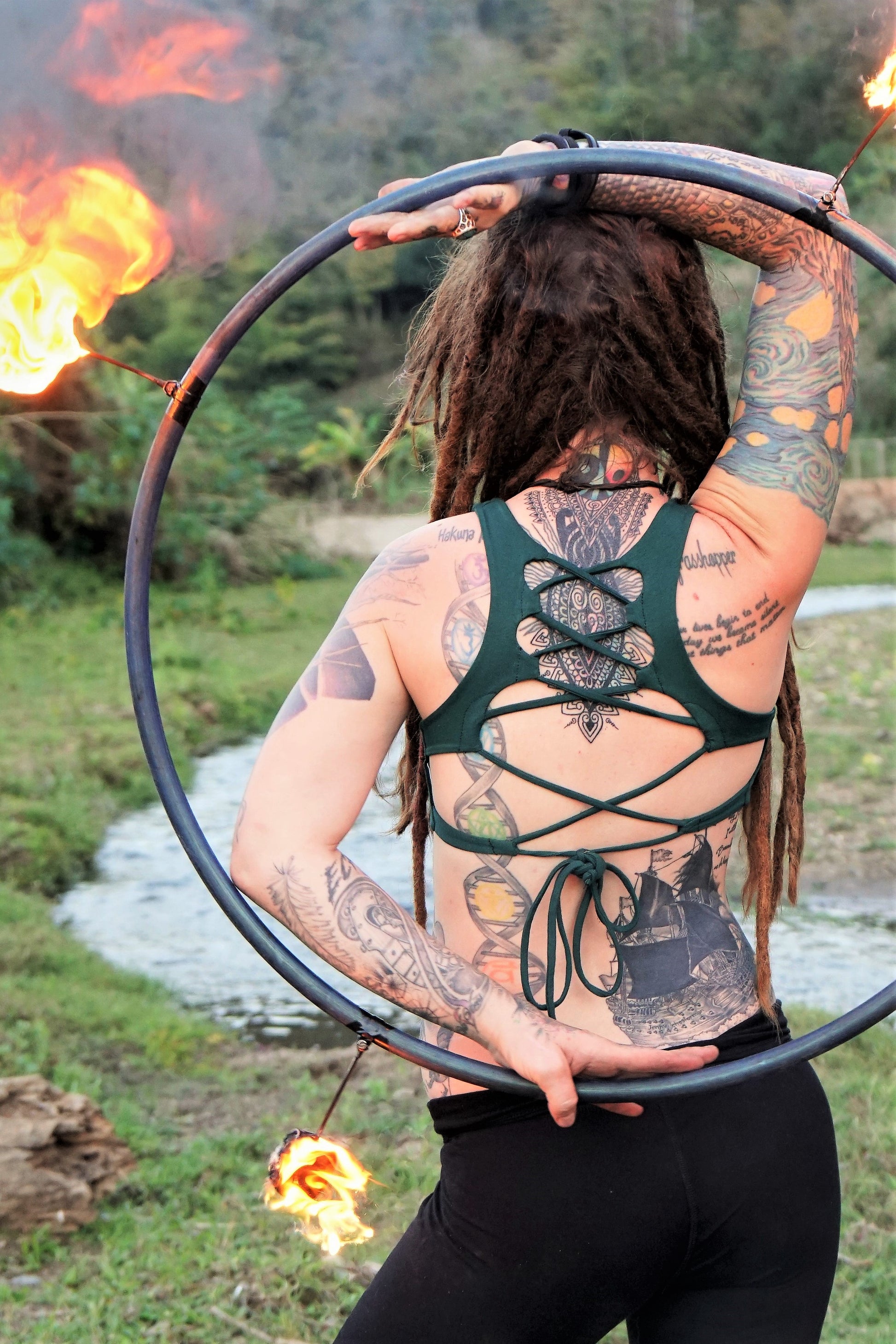 Forest green yoga crop top bra that accentuates the natural beauty of a woman's back with light support and lace up corset back, perfect for festival season.