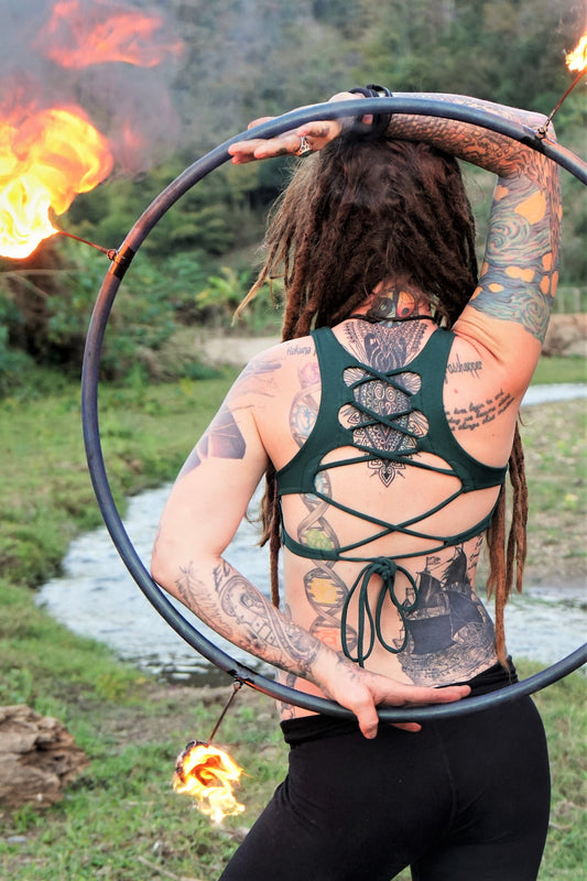 Forest green yoga crop top bra that accentuates the natural beauty of a woman's back with light support and lace up corset back, perfect for festival season.