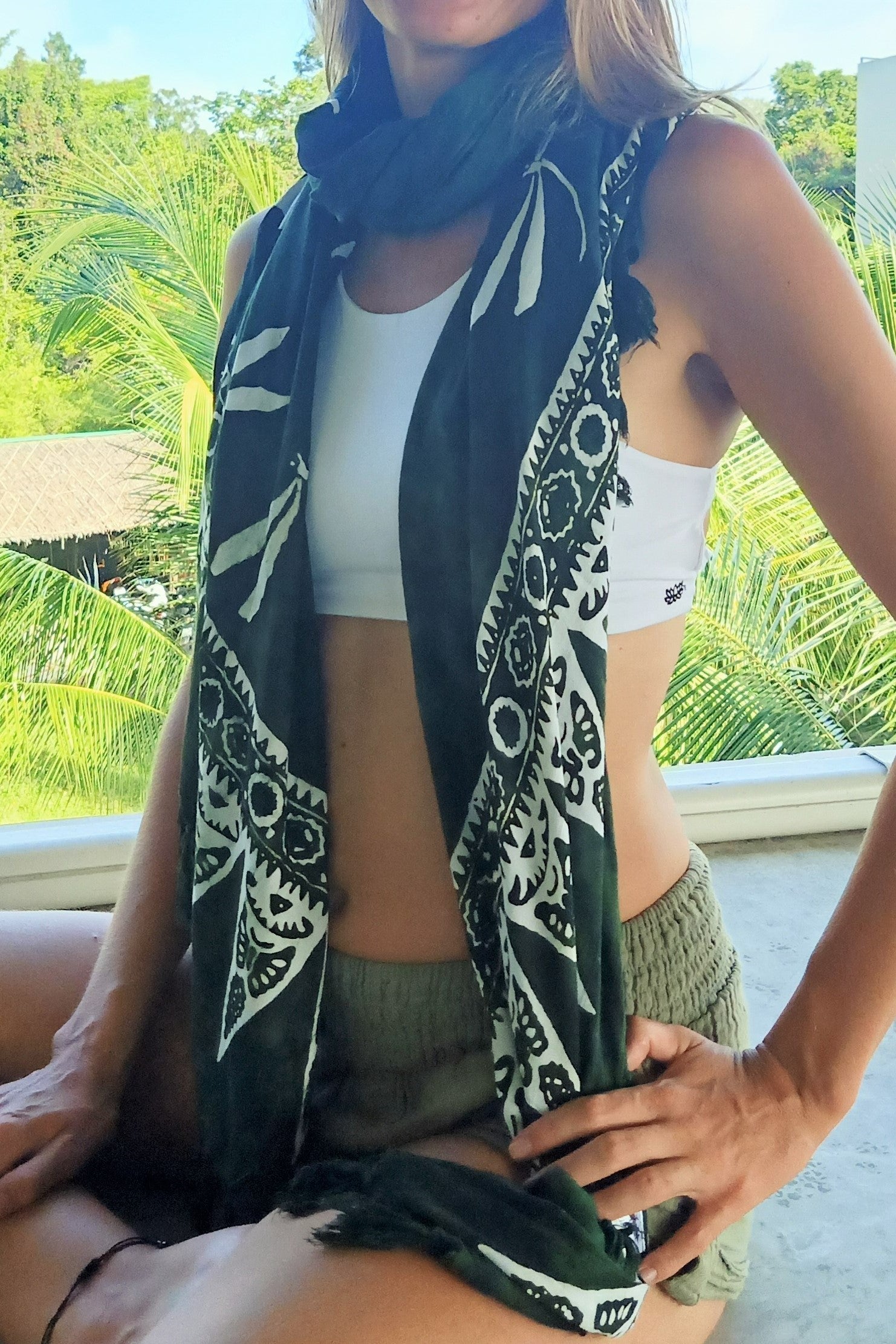 Green sarong worn as scarf. 100% rayon hand made in traditional batik style with white dragonfly pattern.