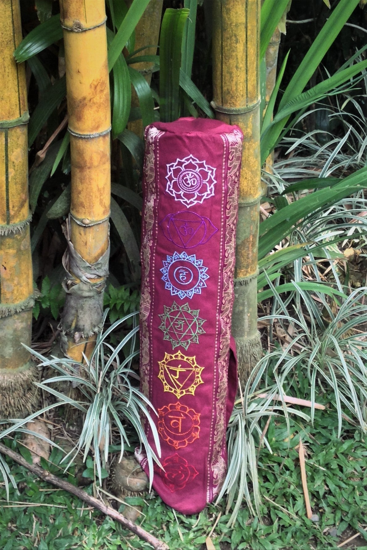 Yoga Mat Bag with Chakra embroidery in Maroon has elephant trim in gold. Zip closure with adjustable length strap.