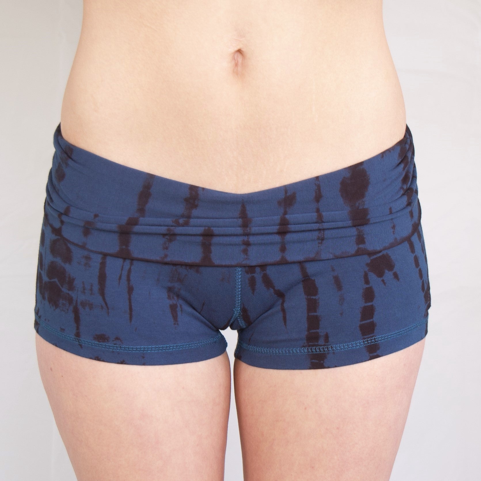 Front view of Lotus Tribe Clothing's Midnight tie dye Yoga Shorts with fold top waist. Beautiful blue with black streaks pattern.