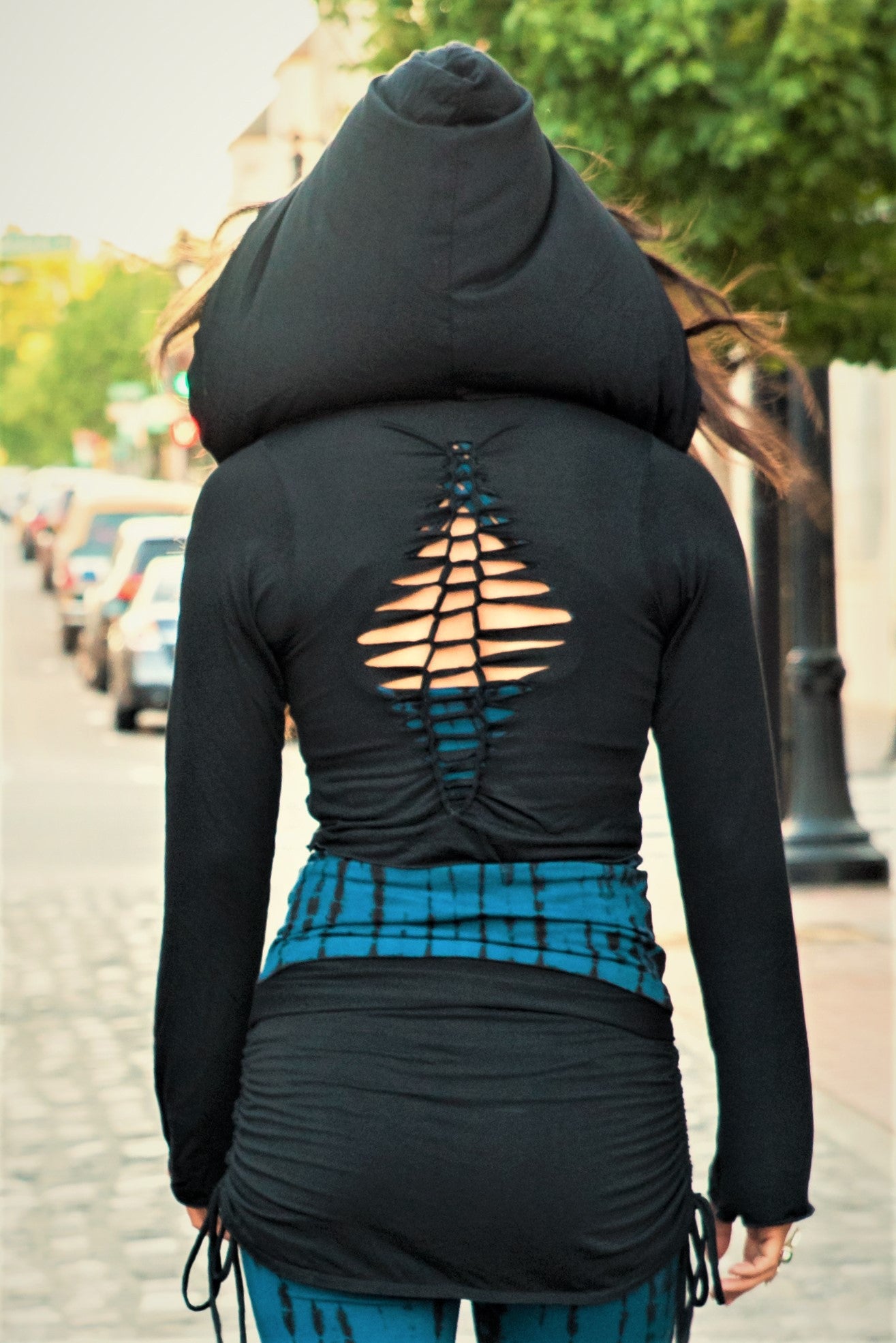 Back view of Long Sleeve Onyx Ninja Jacket Wrap. Comes with oversized hood and see thru detail on back. Soft and silky, perfect for layering over a sportbra after yoga class or as streetwear