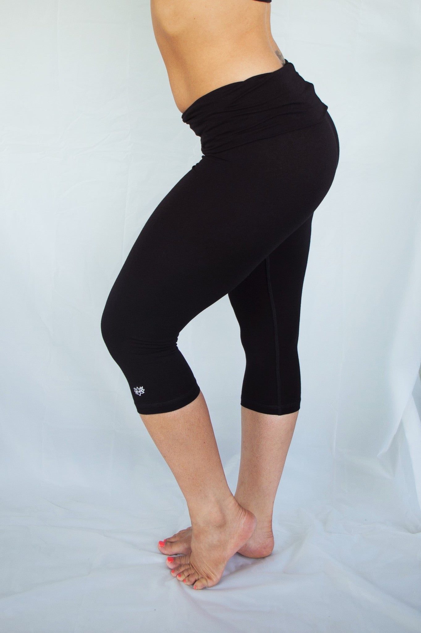 Solid colored black 3/4 length Yoga Pants have a fold over waist that is adjustable to fit a longer torso or be worn lower on the hips. Soft 90% cotton and 10% spandex.