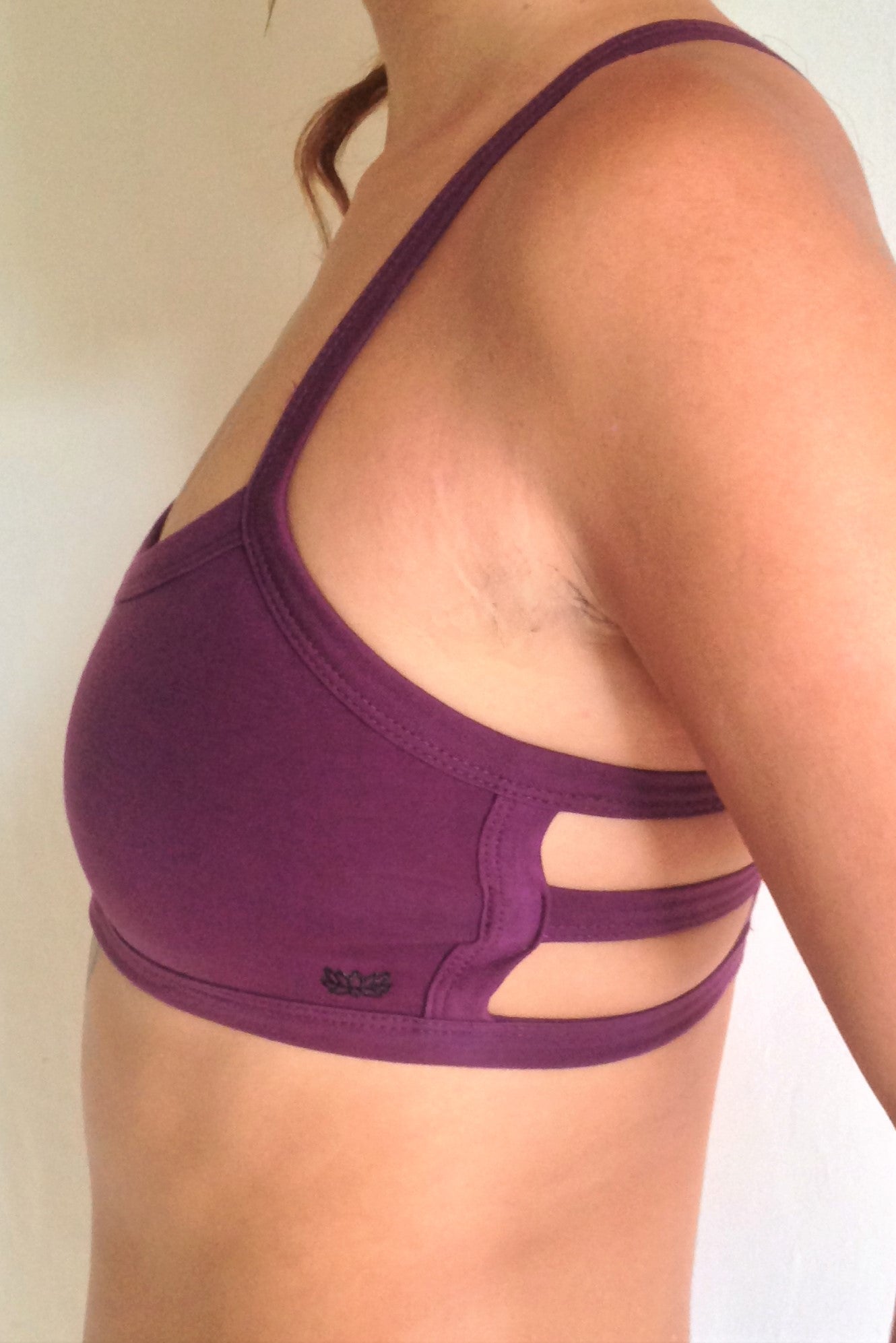 Side view of Plum Trinity, One of the most comfortable sports bras you will ever wear, soft and super cute. Solid purple front with 3 horizontal straps across back 90% cotton 10% spandex