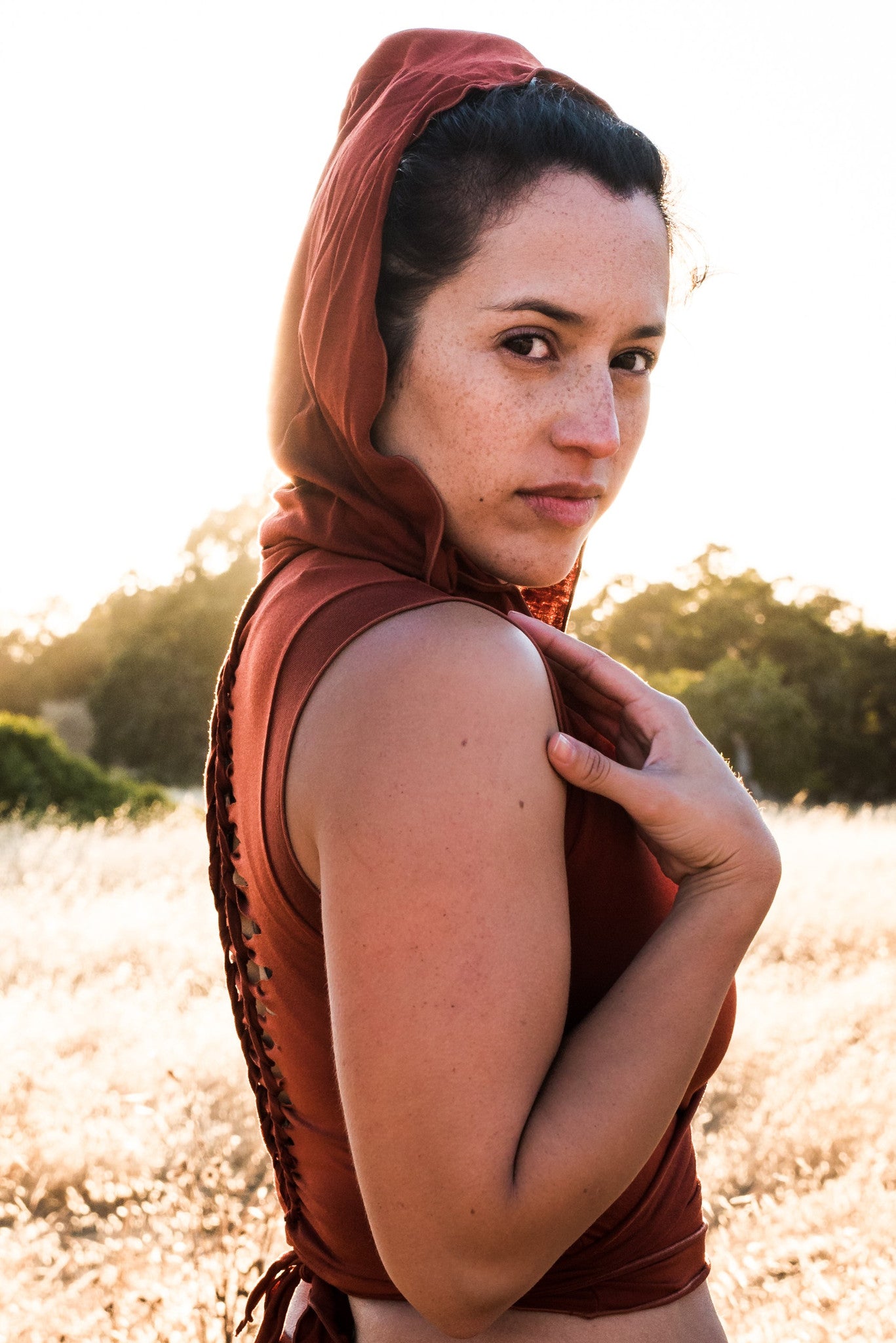 Sleeveless Rust Ninja Wraps come with oversized hood and see thru detail on back. Soft and silky, perfect for layering over a sportbra after yoga class or as streetwear