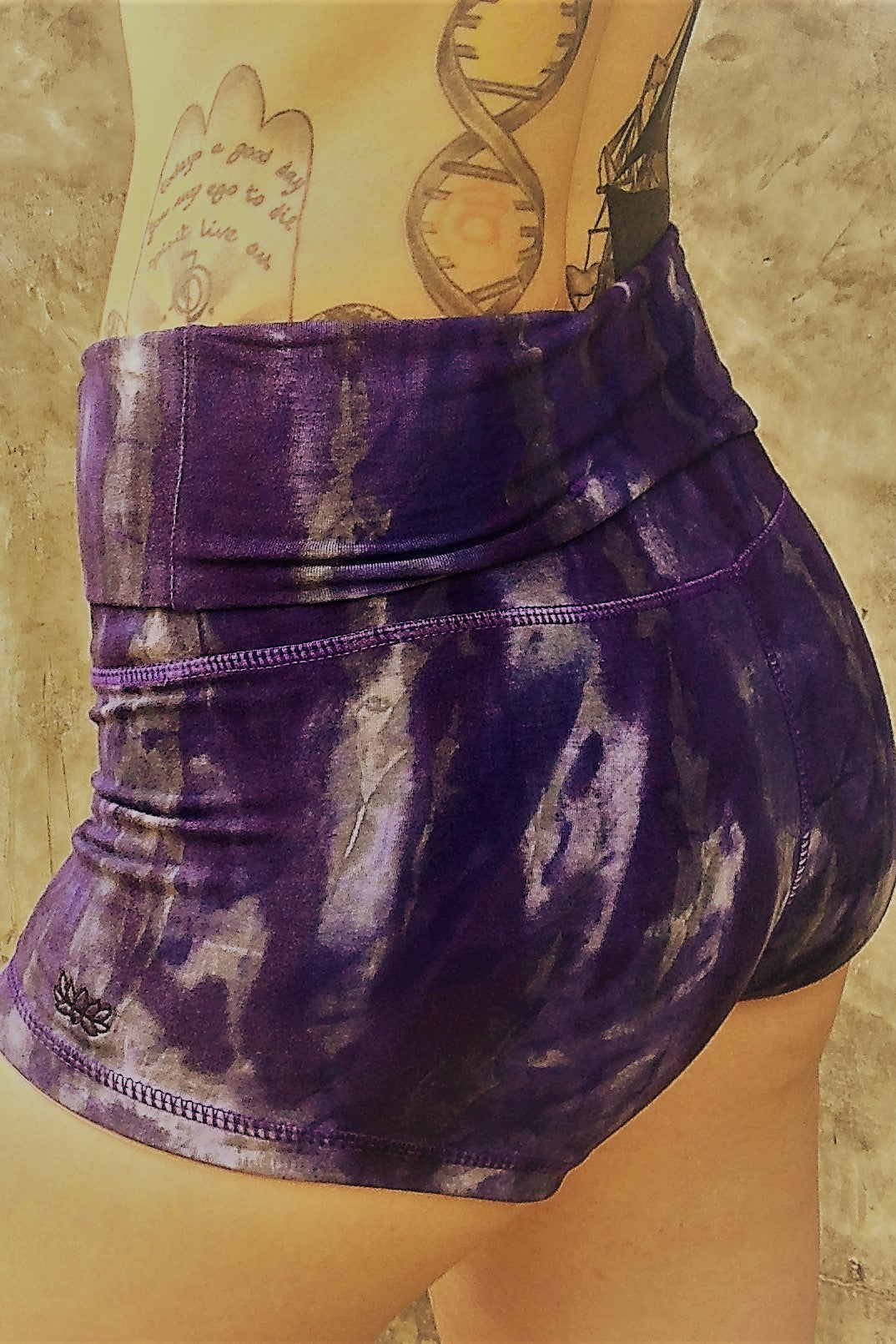 Comfortable, flattering high quality 90% Organic Cotton with 10% spandex knit into soft stretchy yoga shorts with fold over top for adjustable fit can be worn with higher waist or lower on the hips. Gorgeous cool purple hues with grey and possibly white highlights and small lotus flower embroidery on side.