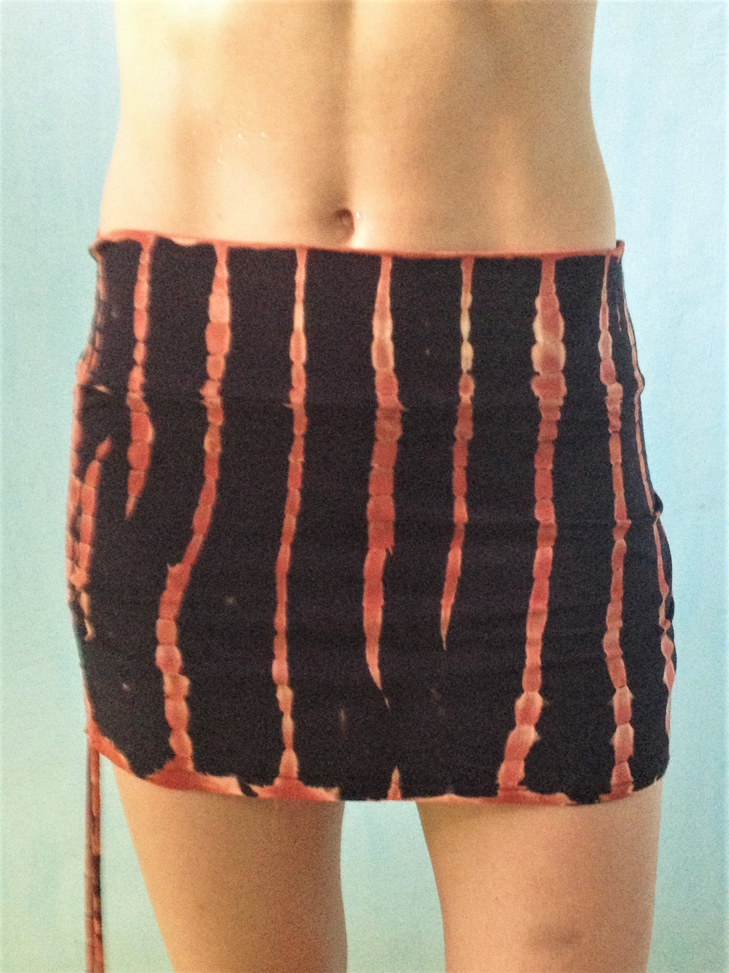 Cute little black and orange tie dyed mini skirt with pull strings on the sides and fold over waist for custom fit. Soft, stretchy and comfortable rayon knit.