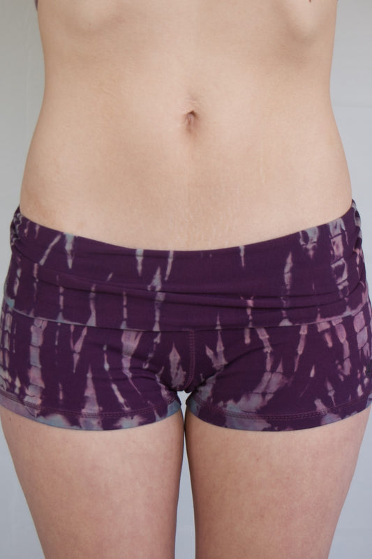 Lotus Tribe Clothing's curve hugging purple with lavender highlights tie dyed short shorts with fold over waist are soft and comfortable. Ethically made of 90% cotton 10% spandex