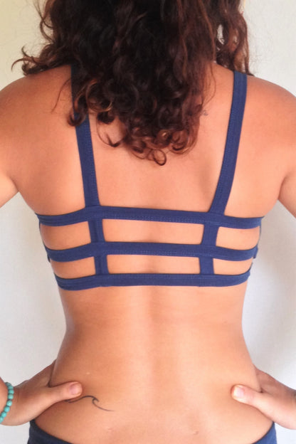 Back view showing with 3 horizontal straps across back. One of the most comfortable sports bras you will ever wear, soft and super cute. Solid Cobalt blue front . Medium support.