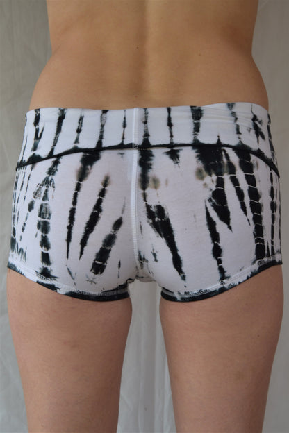 Soft and comfortable crisp white with black tie dyed yoga shorts with fold over waist for adjustable custom fit, can be worn higher waisted, or low on the hips.