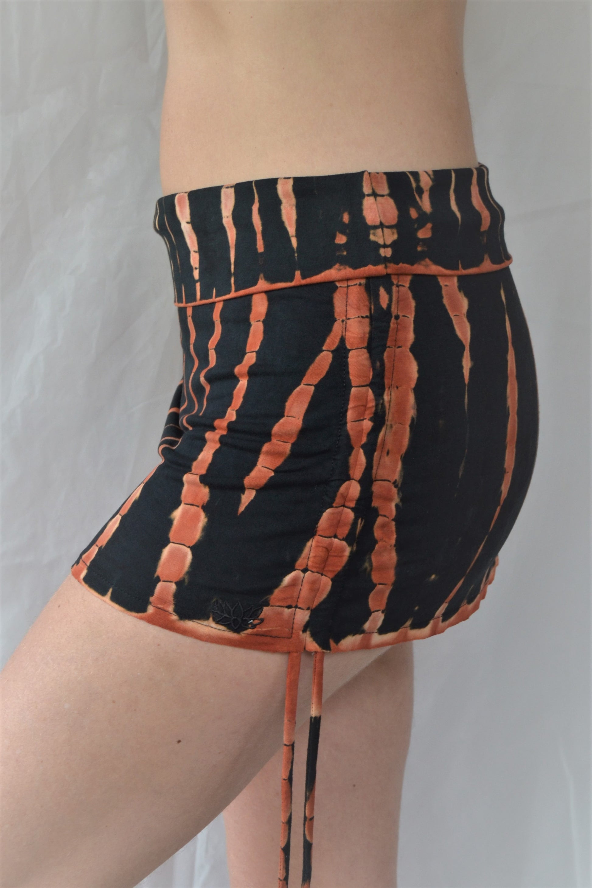 Cute little black and orange tie dyed mini skirt with pull strings on the sides and fold over waist for custom fit. Soft, stretchy and comfortable rayon knit.