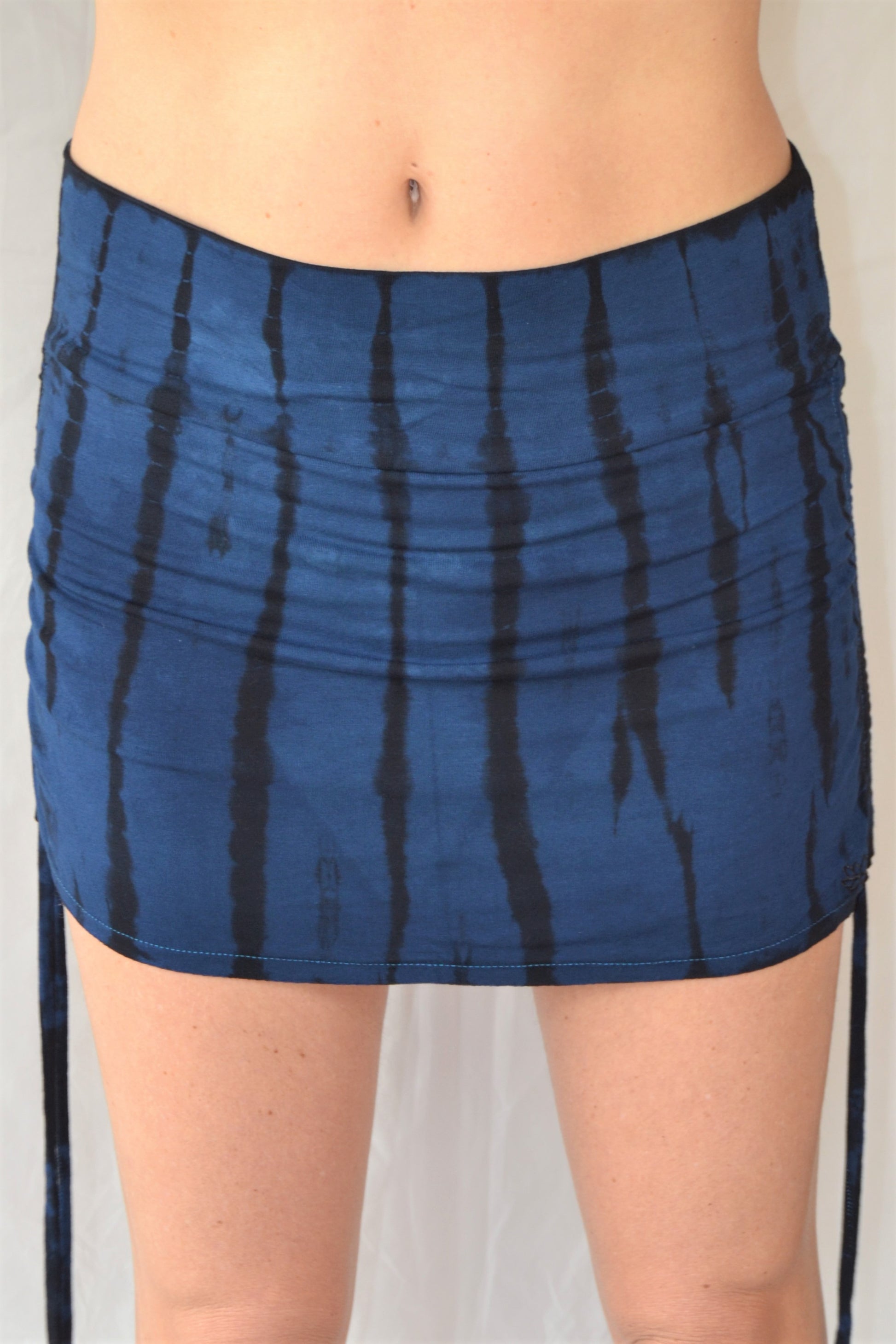 Cute little blue and black tie dyed mini skirt with pull strings on the sides and fold over waist for adjustable fit. Soft and comfortable 90% rayon 10% cotton.