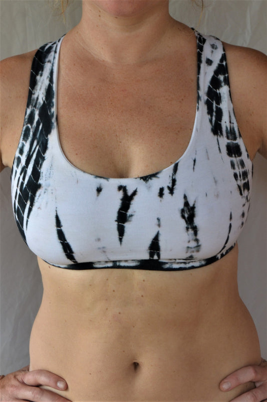 Soft, comfortable and super cute black and white tie dyed sports bra with criss cross straps on back.