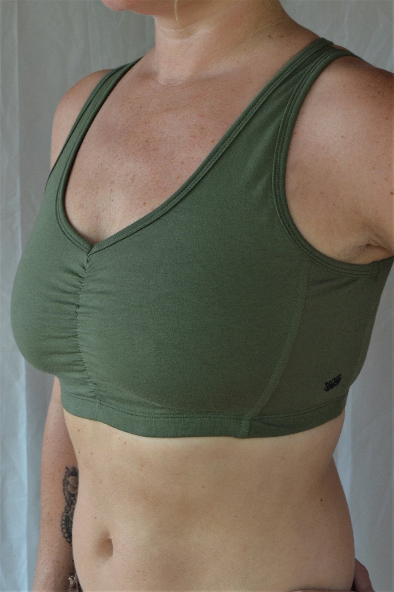 Sage green SportsBra with "sunburst" design straps on back. Fits large chested active women especially while still being soft, cute, comfortable and functional.