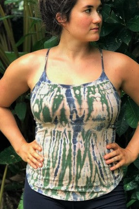 Jasper tie dye tank with spaghetti straps and rounded bottom has peachy background with grey and green tie dyed streaks. 