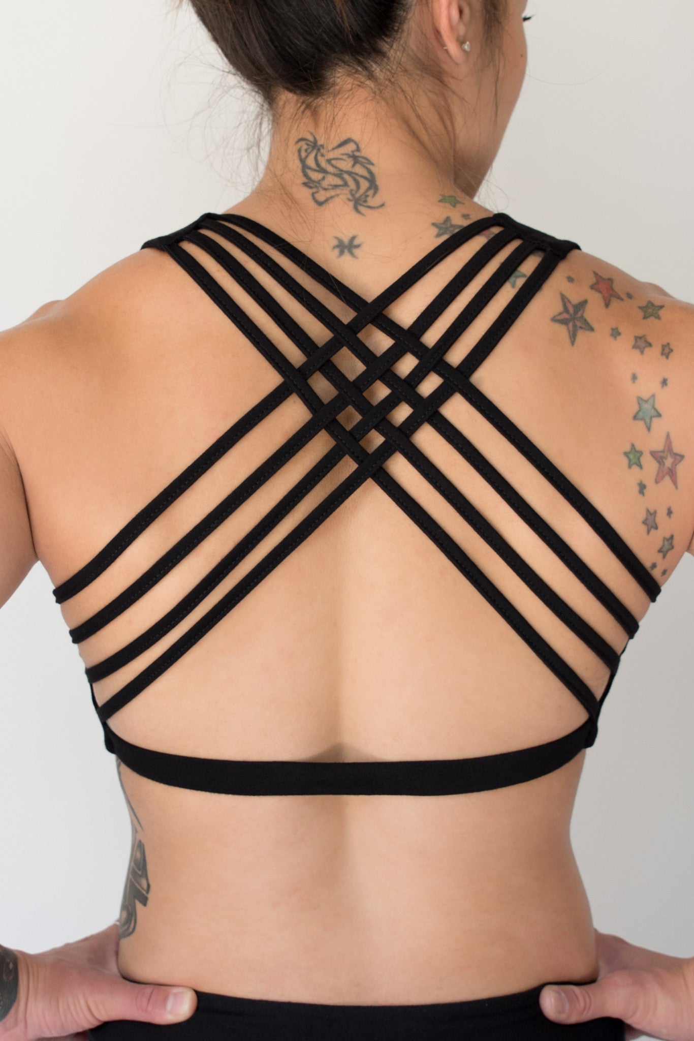 Back view shows 4 criss cross straps of Onyx Sports Bra with silver tree design on front...Soft, comfortable and super cute with enough support for yoga, gym, cross fit, running, or whatever fitness you enjoy, without the girls falling out.