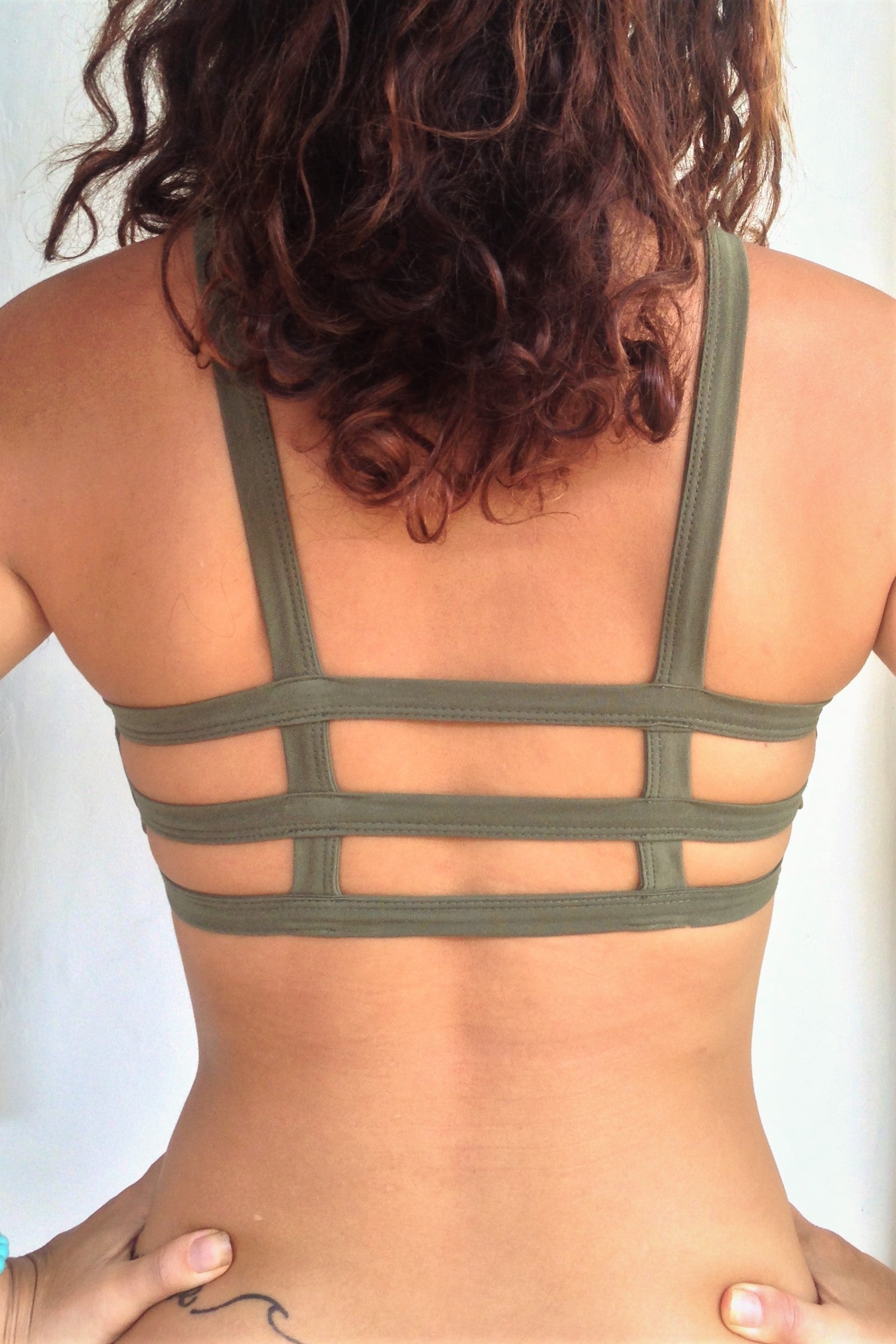 Back view of Trinity Sportsbra shows with 3 horizontal straps across back. Bra has solid Sage green front. One of the most comfortable sports bras you will ever wear, soft and super cute . Medium support.