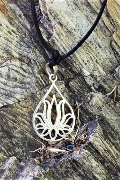 Silver tear drop shaped pendant with lotus flower design on black waxed cotton cord. Vegan friendly.
