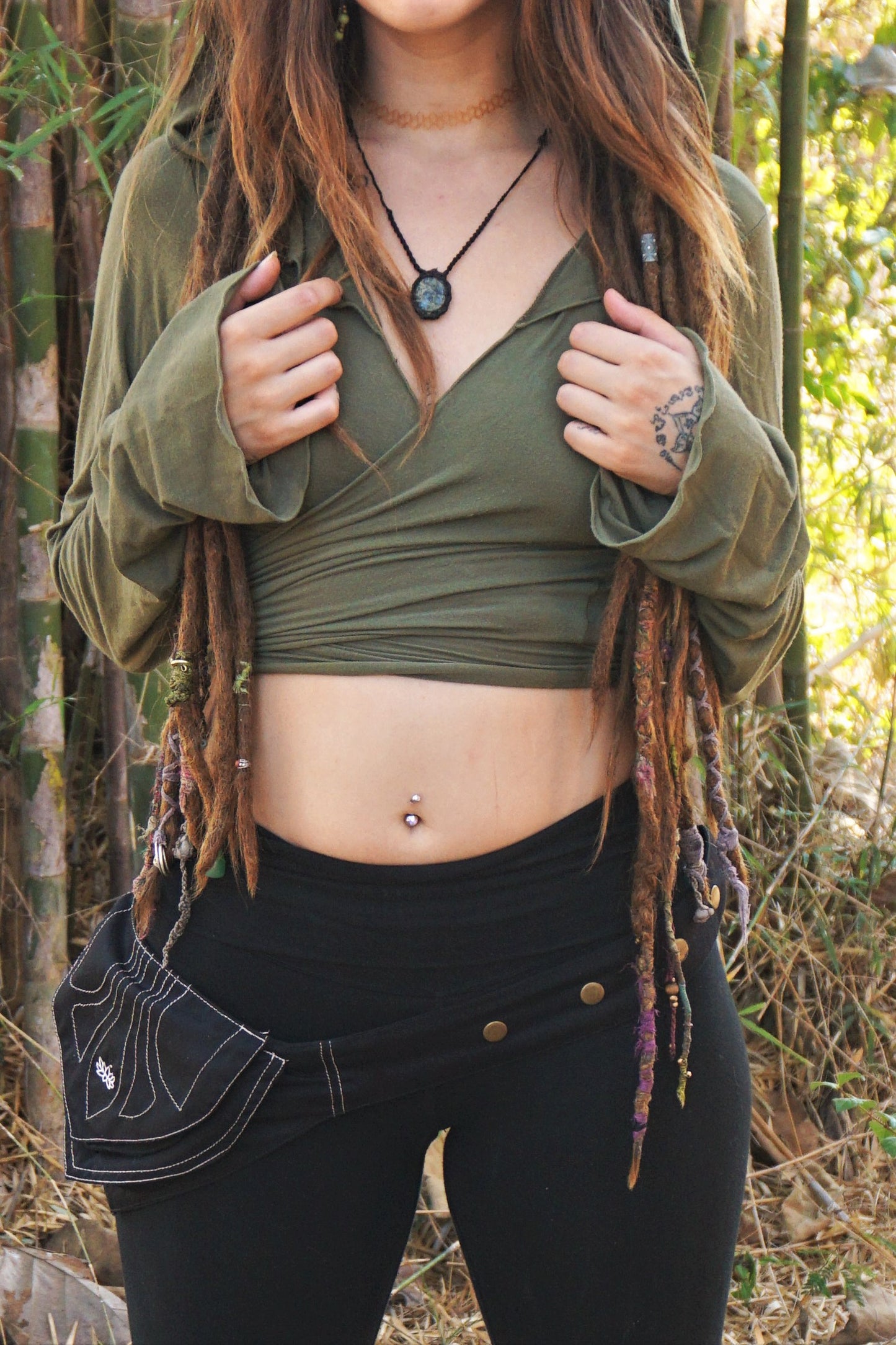 Black Utility Belt worn low on the hips of woman with dreads. 