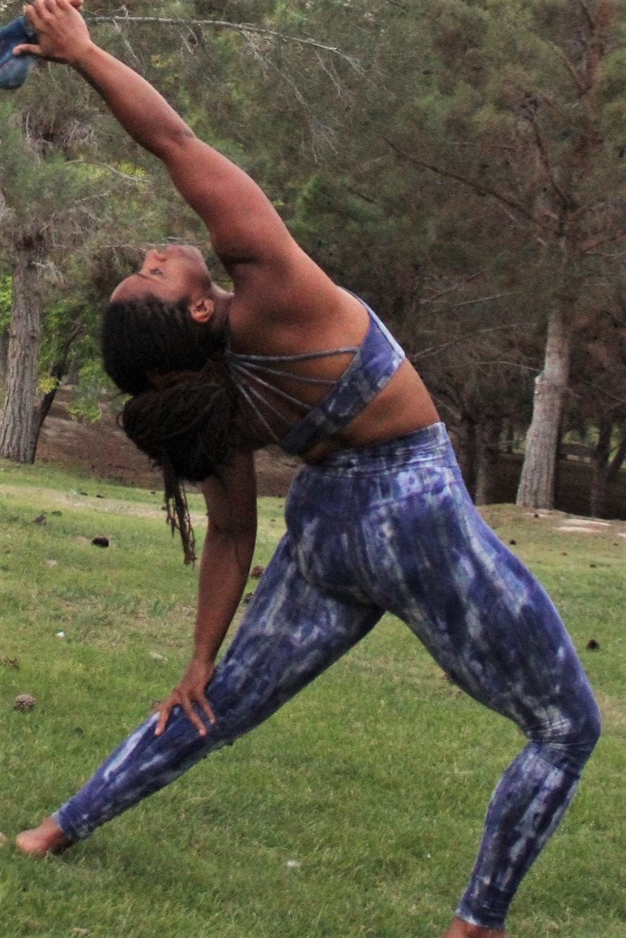 Back view of long length yoga pants with fold over top for adjustable fit. Gorgeous cool purple hues with grey and white highlights shown with matching Shakti Sports Bra. 